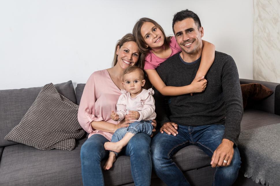 Free Image of Happy family on the couch at home 