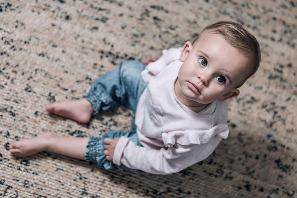 Free Image of Toddler girl sitting in the lounge 