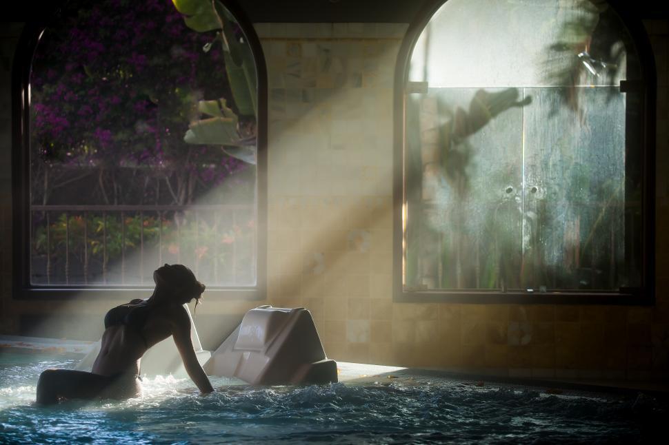 Free Image of Slim woman relaxing in jacuzzi water 