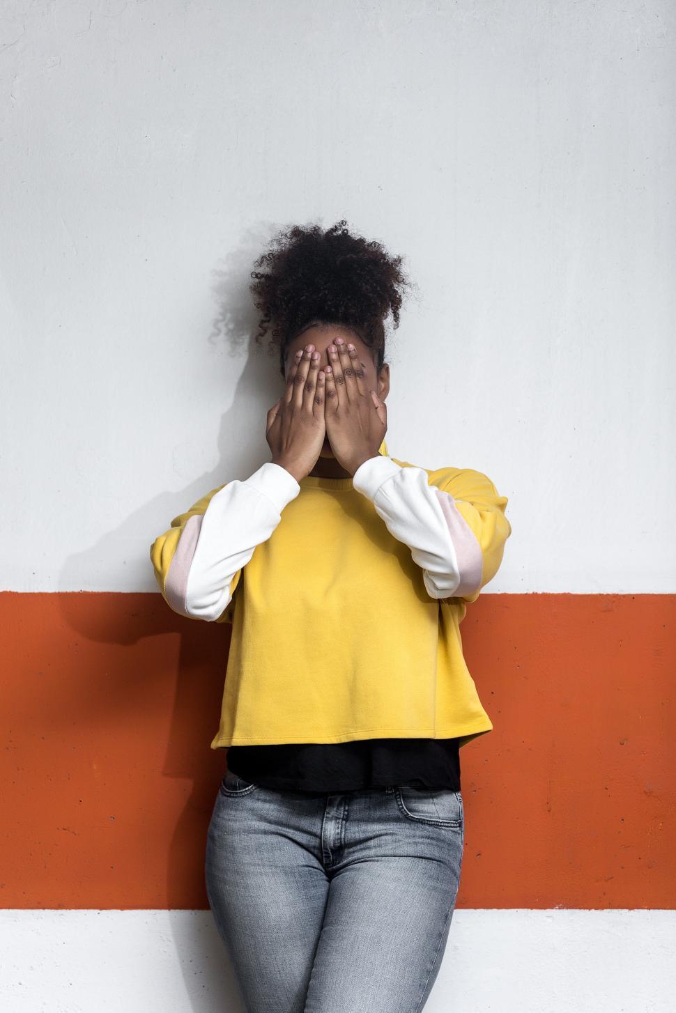 Free Image of Woman in trendy clothes covering face 