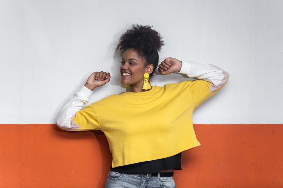 Free Image of Happy ethnic woman in colorful outfit having fun and dancing 