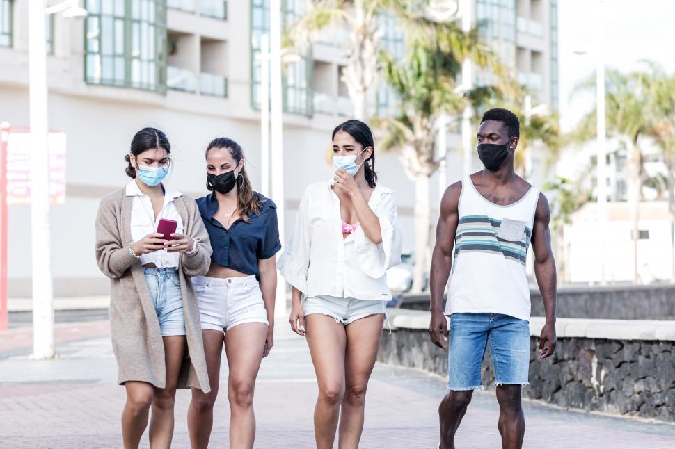 Free Image of Group of multiracial friends walking together in city 