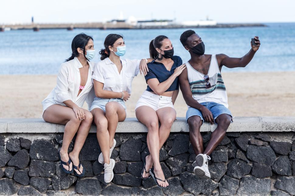 Free Image of Company of multiethnic friends taking selfie on embankment 