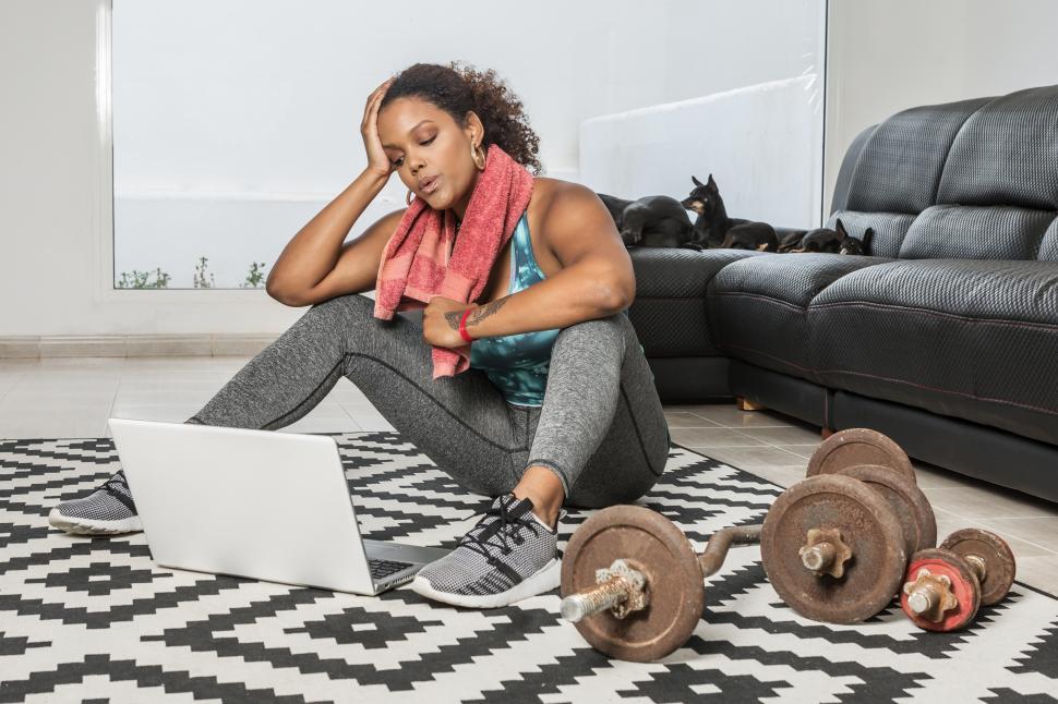 Free Image of Weary sportswoman relaxing after training at home 