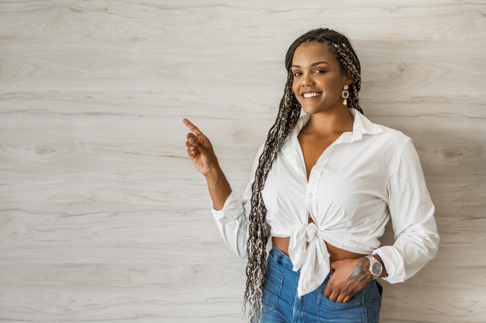 Free Image of Portrait of a smiling adult woman standing pointing up 