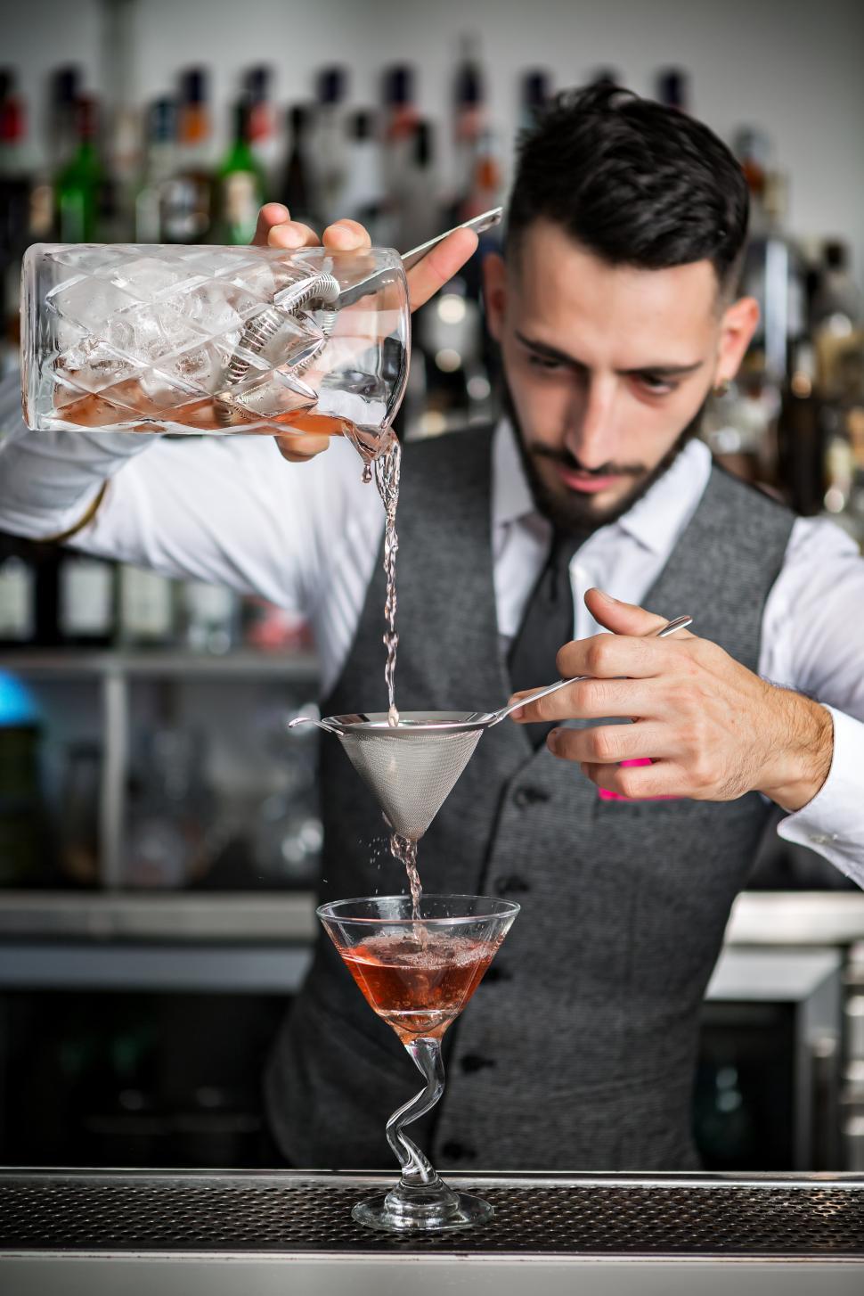 Free Image of Barman filling glass with cocktail 