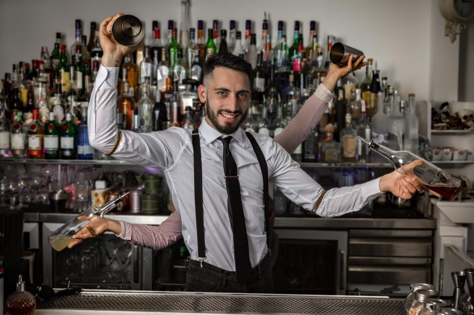 Free Image of Bartenders with shakers and bottles in pub 