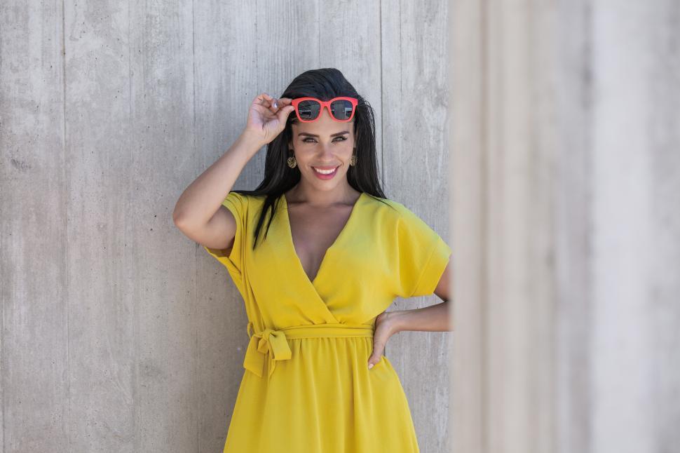 Free Image of View young Latina woman in raising sunglasses 