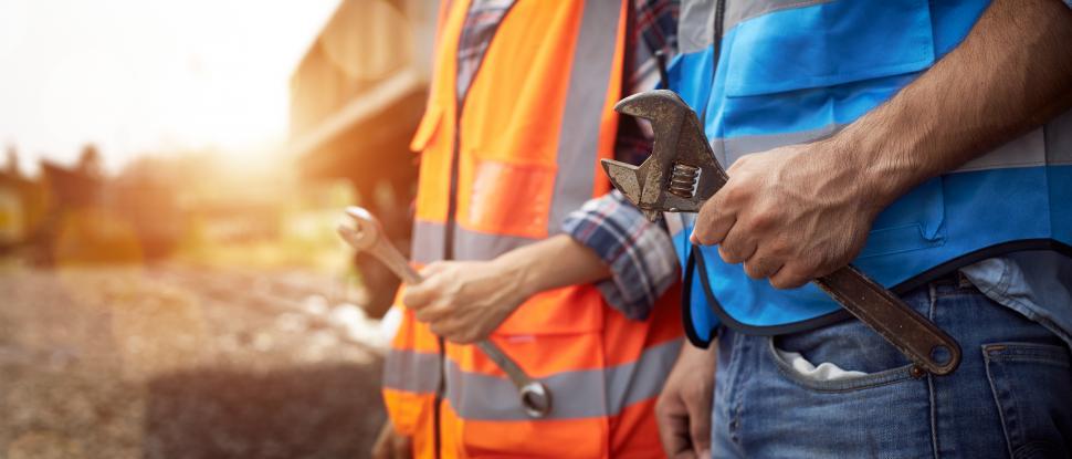 Free Image of Hands of maintenance worker holding a wrench. 