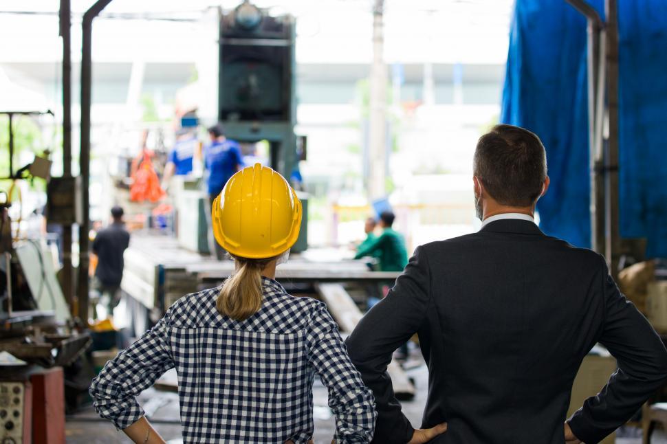 Free Image of Business owner and an engineer discussing factory 