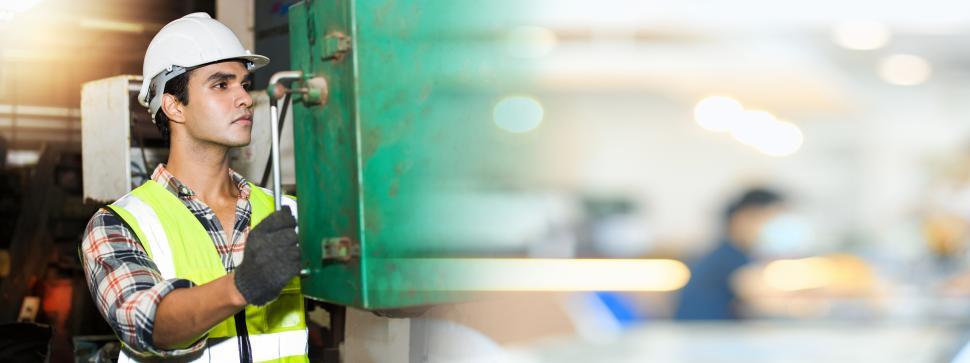 Free Image of Man at controls of industrial equipment 