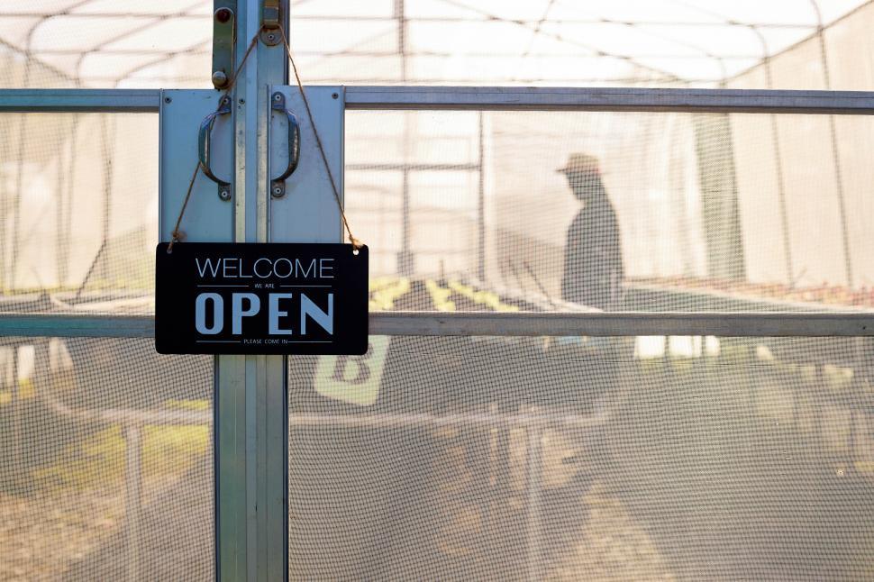 Free Image of Greenhouse growing organic vegetables with an Open sign 