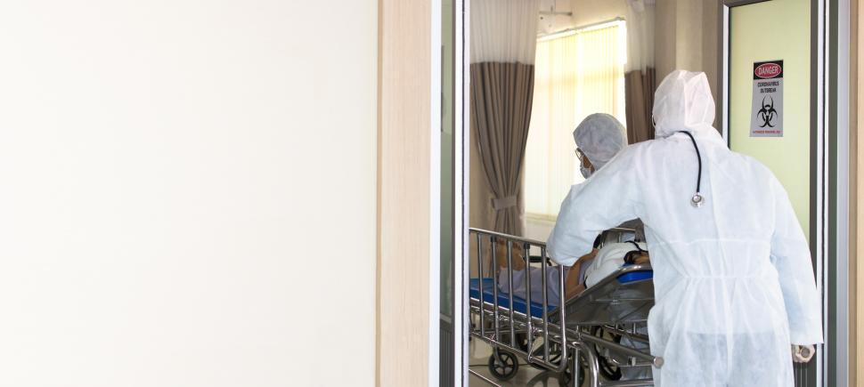 Free Image of Medical staff pushing a patient ill with COVID-19 into treatment 