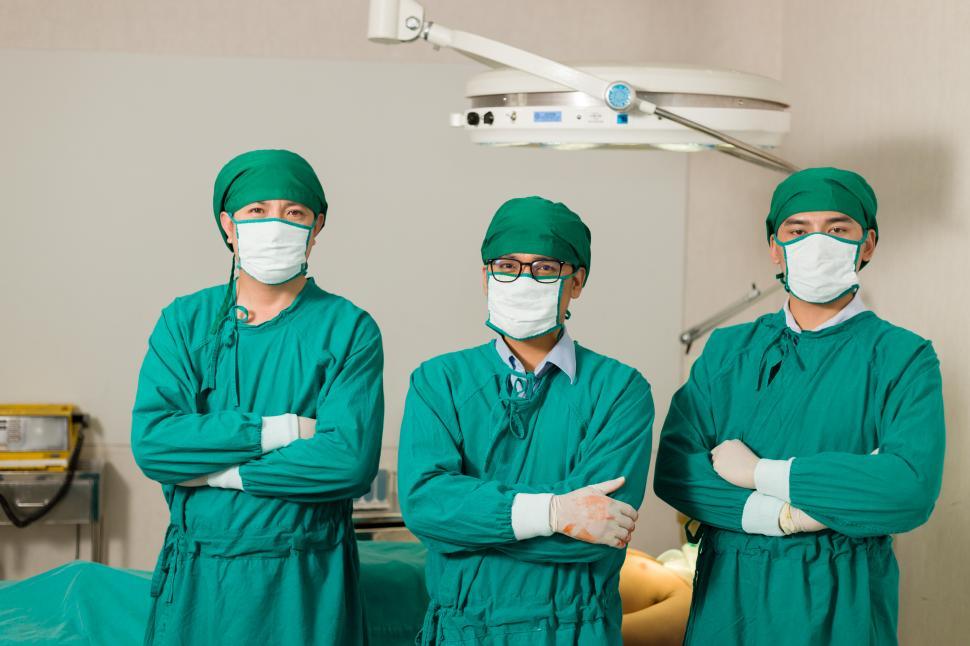 Free Image of Surgeon or doctor standing and crossed arms in the operating room 