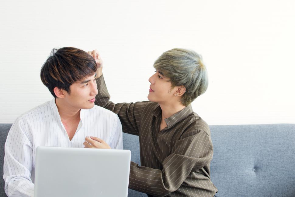 Free Image of Gay couple relaxing on the sofa. 
