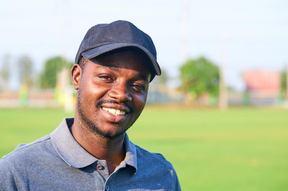 Free Image of Golfer wearing sport hat standing in an outdoor golf course 