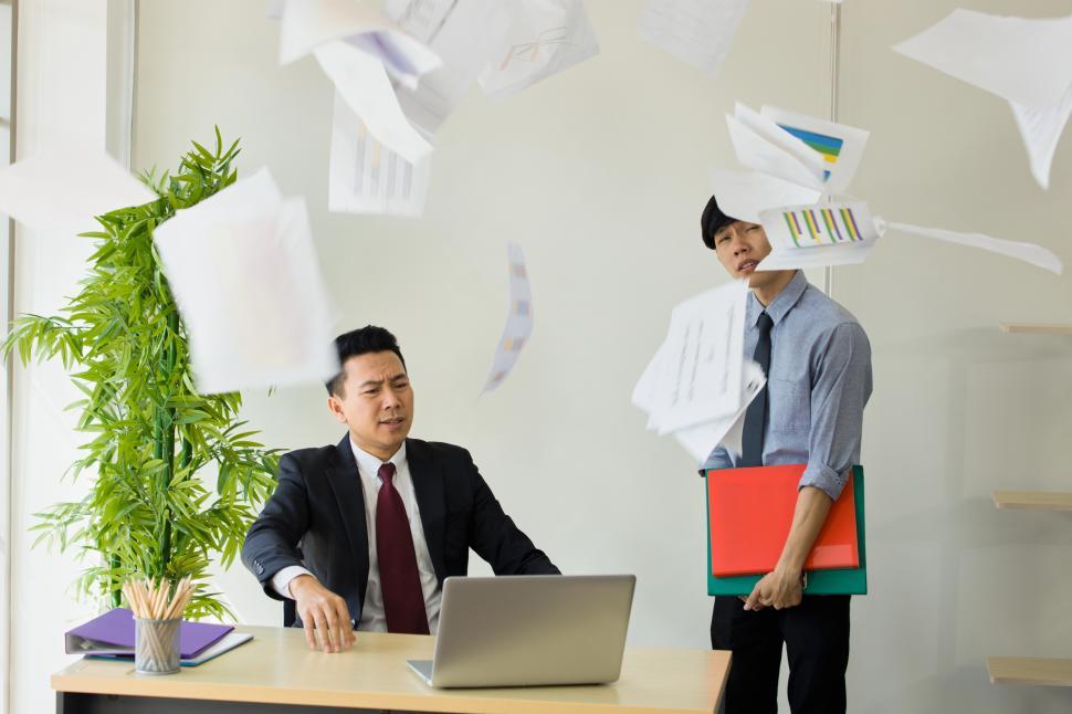 Free Image of Furious employer throws documents 