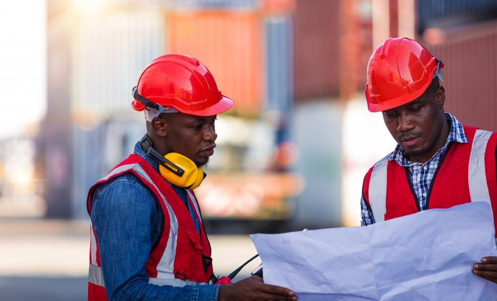Free Image of Engineers managing work in a container yard 