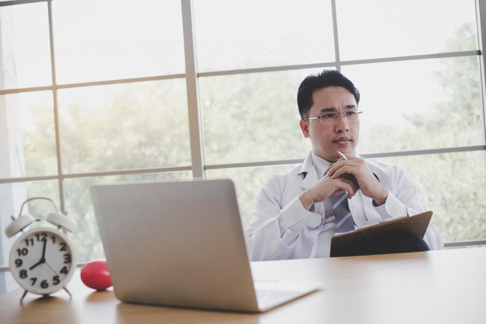 Free Image of Doctor is working at a desk in the morning 