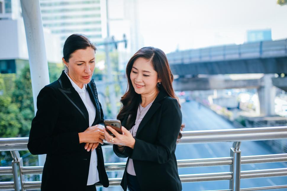 Free Image of Businesswoman looking at a smartphone 