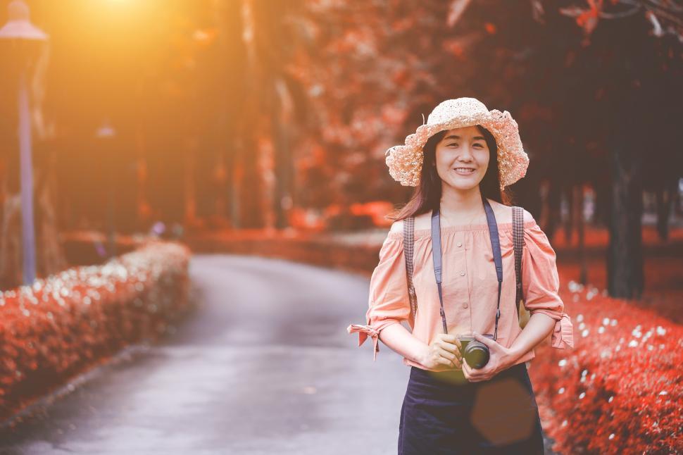 Free Image of Woman on road with camera 