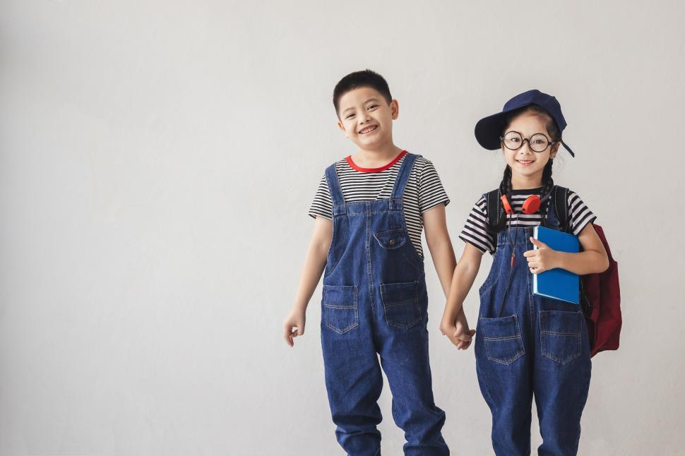 Free Image of Back to school - Little boy and little girl hold hands on first day. 