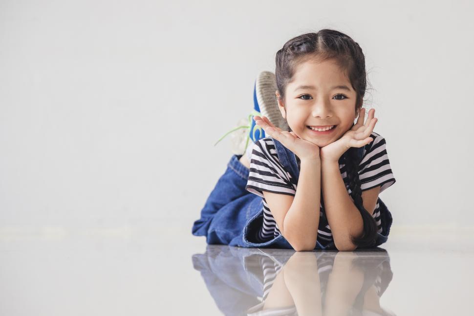 Free Image of Cute little girl put her hand on the chin 