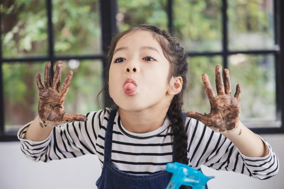 Free Image of Muddy kid being sassy, sticking out tongue 