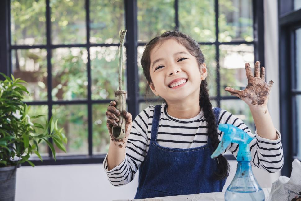 Free Image of Happy kid is dirty after planting garden plants 