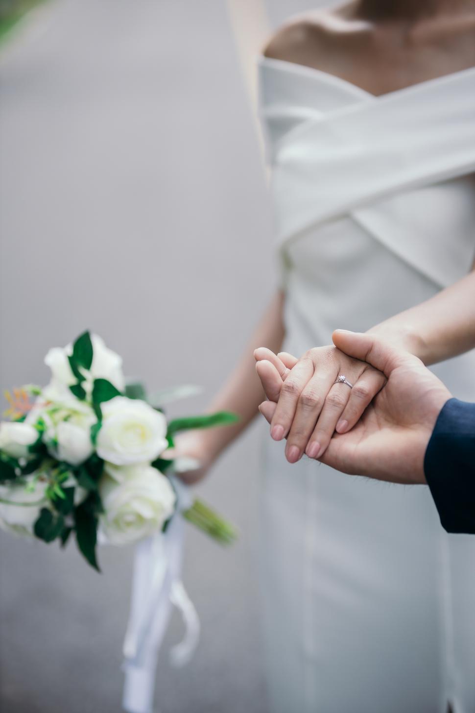 Free Image of Close-up image of the bride and groom holding hands 
