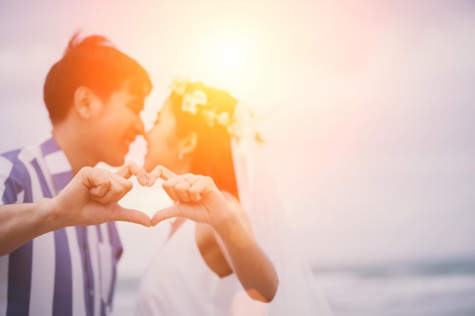 Free Image of Valentines day, Young couple make heart-shaped hands with kiss 