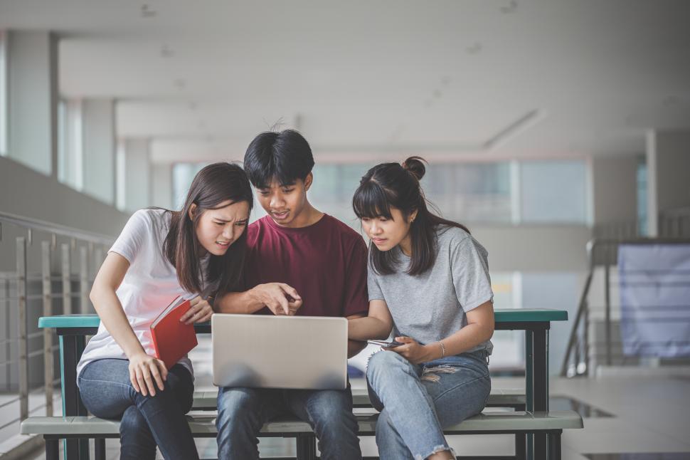 Free Image of Student showing others information on laptop 