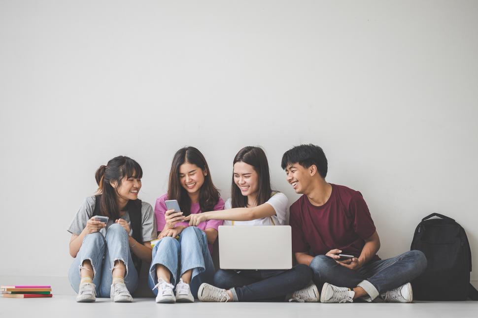Free Image of Group of happy students looking at social media 