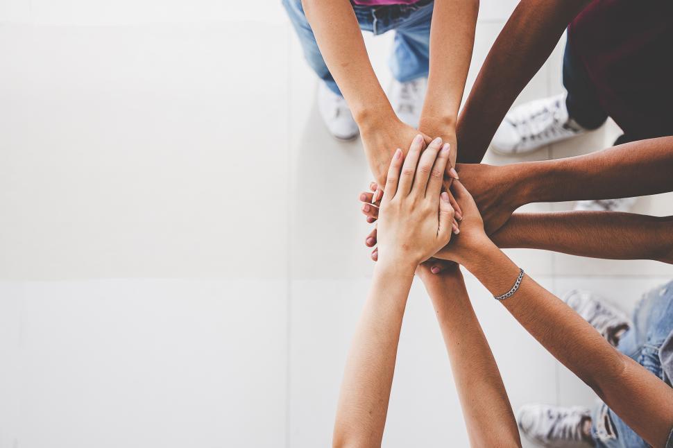 Free Image of Top view of team hands together - hands in with copyspace 