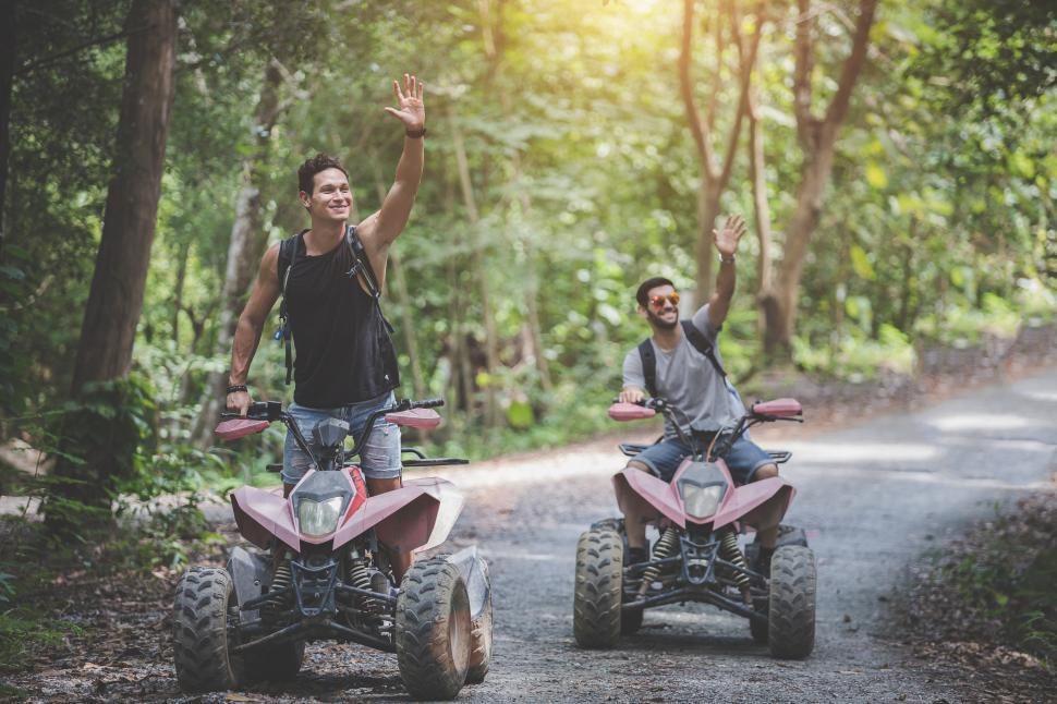Free Image of Off road motorcycle ATV riders waving 