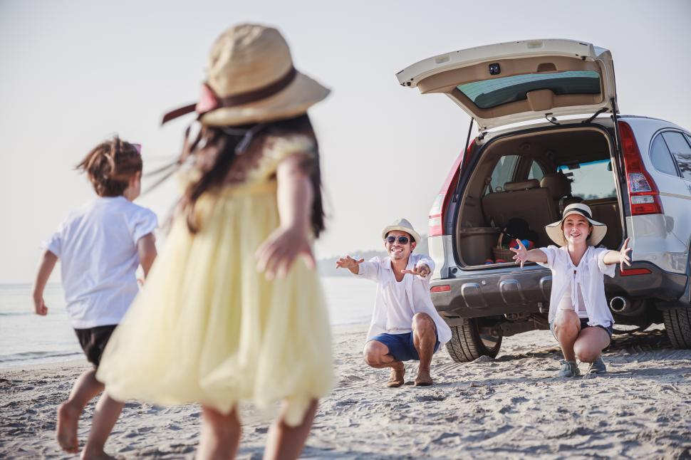 Free Image of Happy family with children playing at the beach 