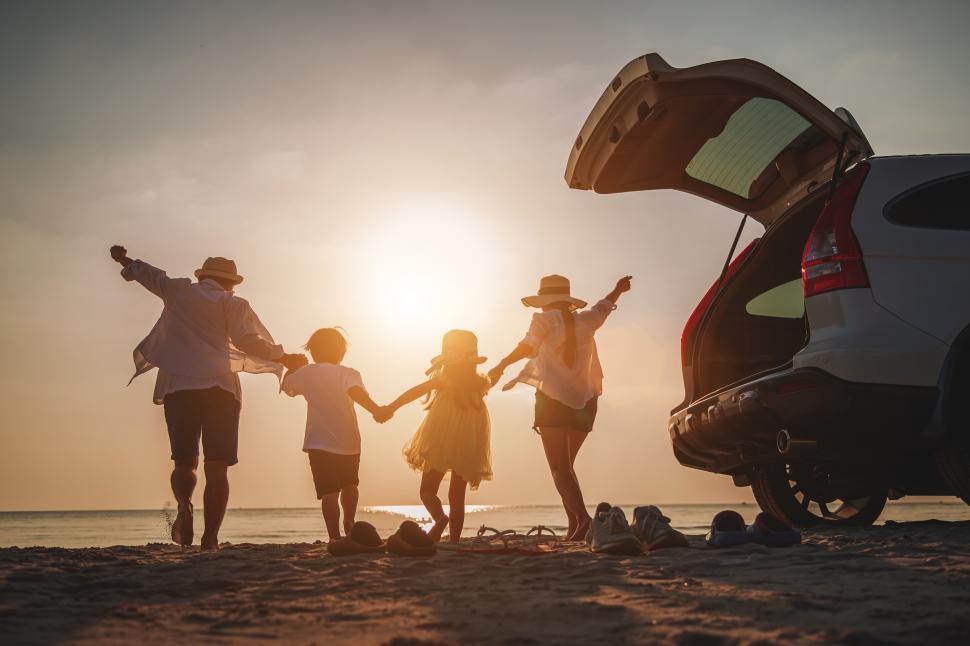 Free Image of Happy family on tropical beach at sunset 