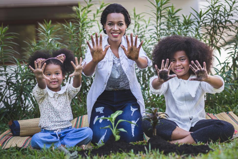 Free Image of Mother is teaching her daughters to work in the garden 