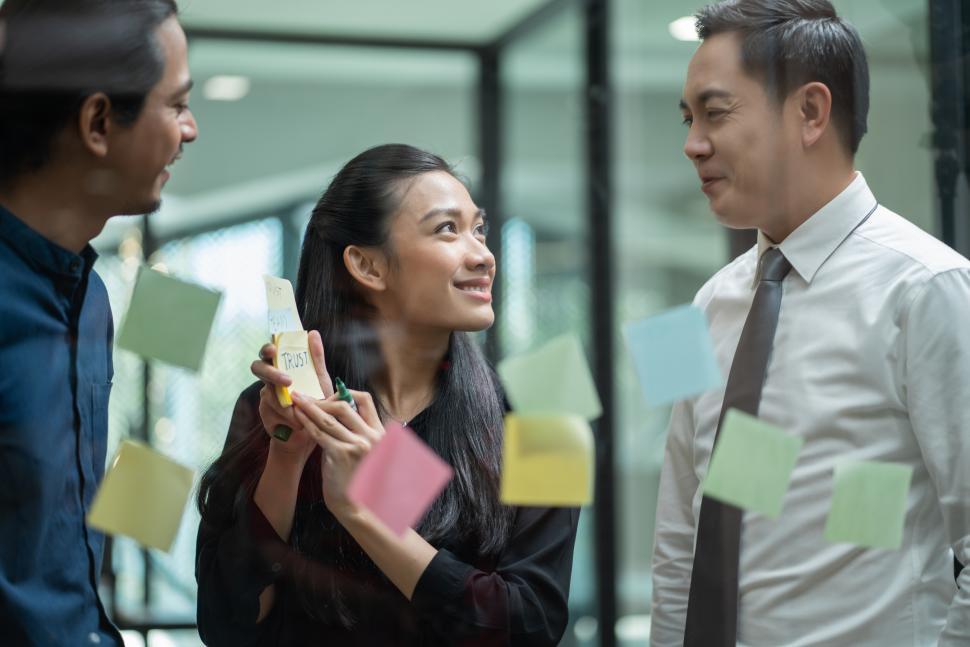 Free Image of Asian business team meeting in the office using post it notes 