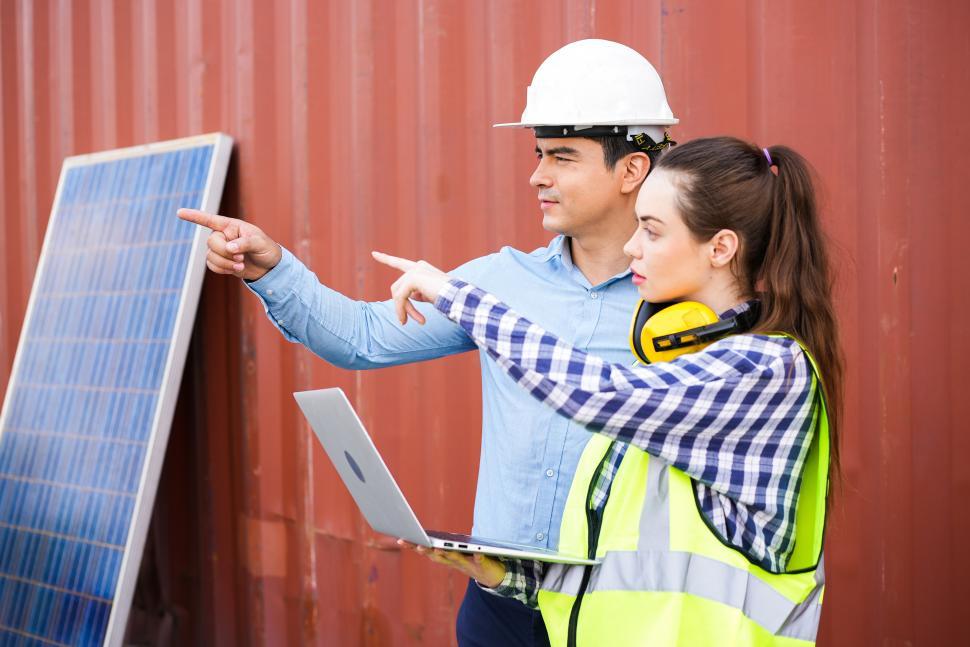 Free Image of Engineer foreman working and discussing solar installation 