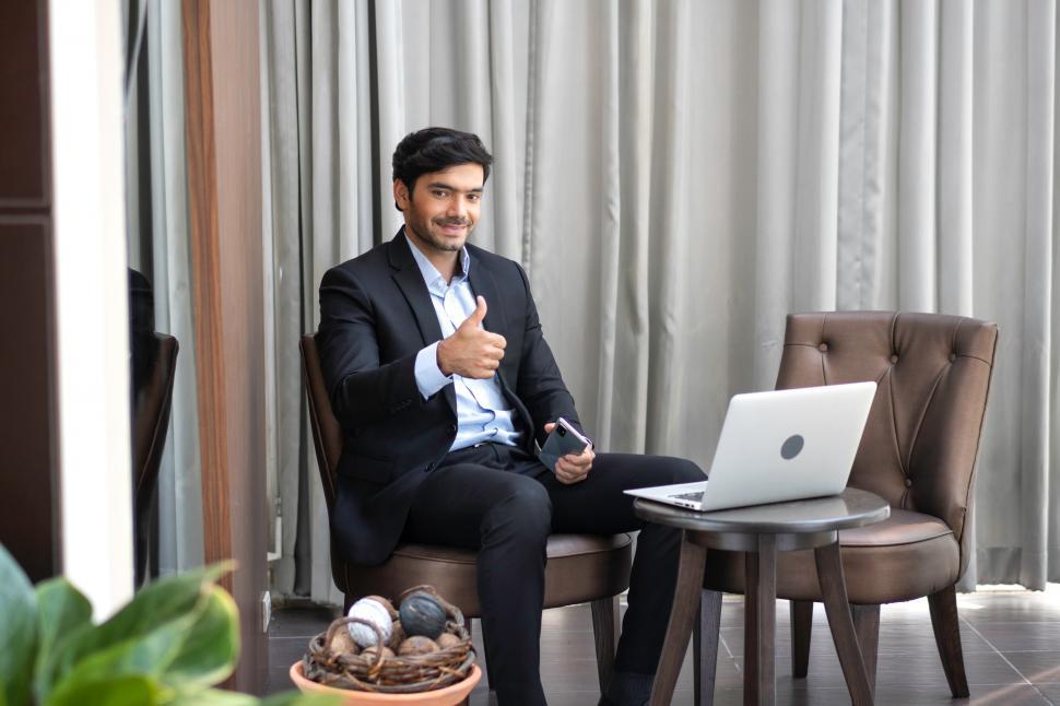 Free Image of Portrait of businessman showing thumbs up 