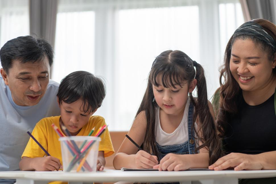 Free Image of Parents teaching and helping kids to do homework 