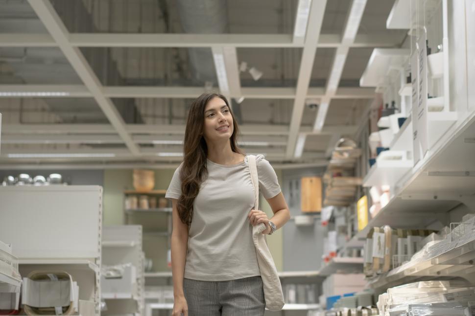 Free Image of Female customer with tote bag walking and shopping 