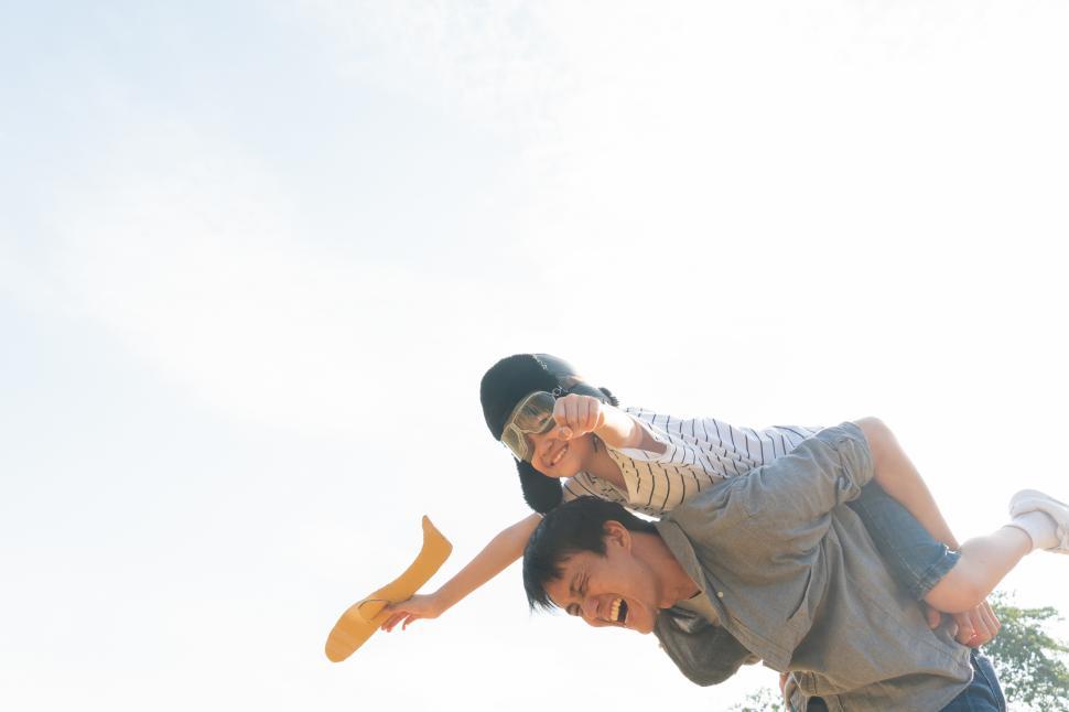 Free Image of Boy wearing pilot helmet on fathers shoulders 
