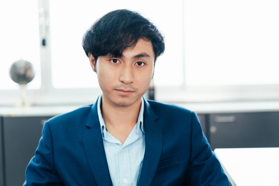 Free Image of Portrait of business man sitting at desk in the office 