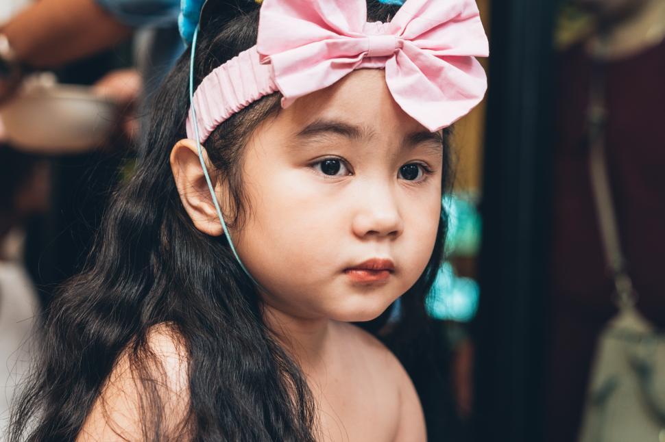 Free Image of Young girl wearing dress with pretty headwear 