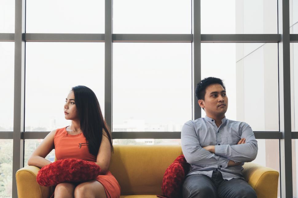 Free Image of Unhappy couple feeling bad after argument on the couch 