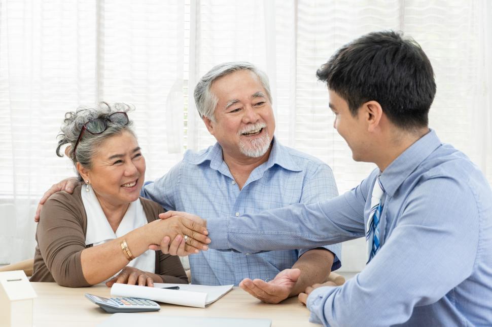 Free Image of Happy senior couple make real estate deal 