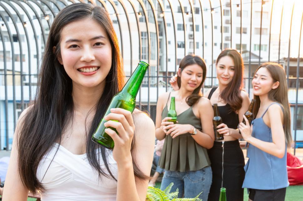 Free Image of Portrait of young woman smiling at the camera at a social gathering 