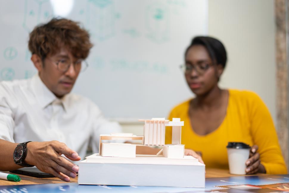Free Image of Architect designer explaining house model to client 